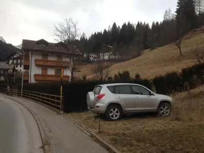 a silver car parked on the side of a road at Casa Katia in Canale dʼAgordo