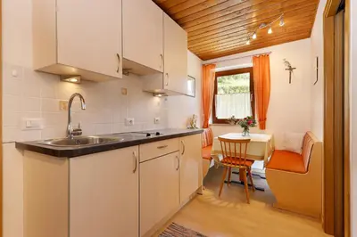 a kitchen with a sink and a table at Goldbichlhof in Lana