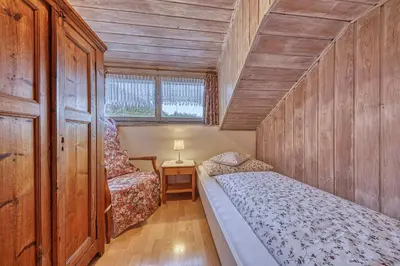 a small bedroom with two beds and a window at Goldbichlhof in Lana