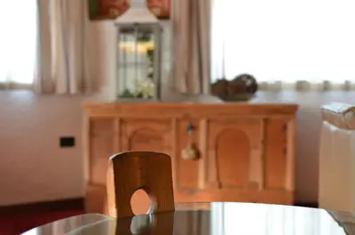 a wooden table in a kitchen with a wooden cabinet at Park Hotel Bellacosta in Cavalese