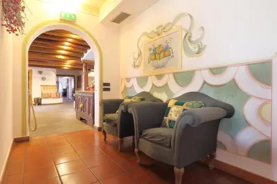 a waiting room with two chairs and a wall at Park Hotel Bellacosta in Cavalese