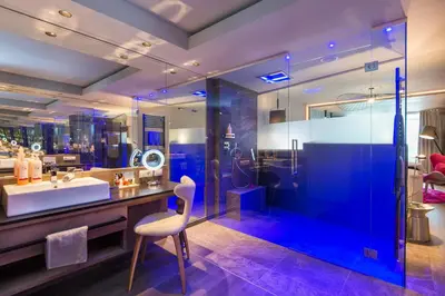 a bathroom with a sink and a shower at Preidlhof Luxury Dolce Vita Resort in Naturno