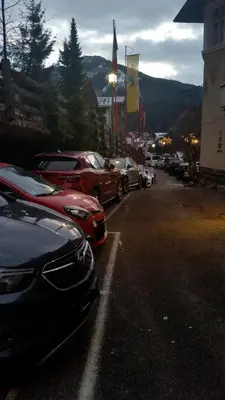 a bunch of cars parked in a parking lot at Hotel Villa Emilia in Ortisei