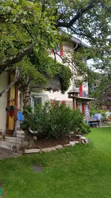 a house with a tree in front of it at Hotel Villa Emilia in Ortisei