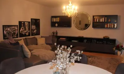 a living room with a couch and a mirror at Villa Falkner in Tirolo