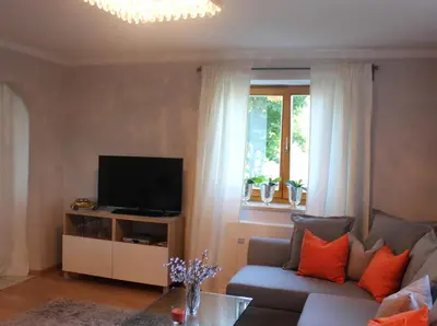 a living room with a couch and a television at Villa Falkner in Tirolo