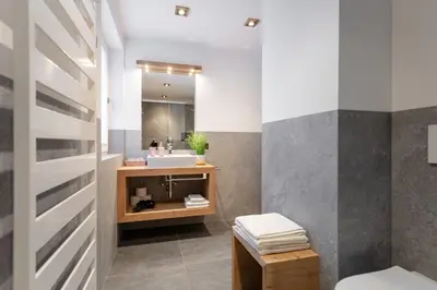 a bathroom with a sink and a mirror at Apartment Cësa Zinch in Ortisei