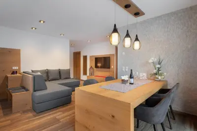 a living room with a table and a couch at Apartment Cësa Zinch in Ortisei