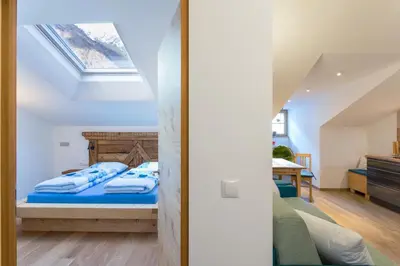 a bedroom with a bed with blue sheets at Ansitz Mairhof in Parcines