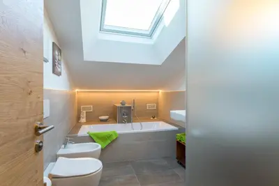 a bathroom with a sink toilet and a bath tub at Ansitz Mairhof in Parcines