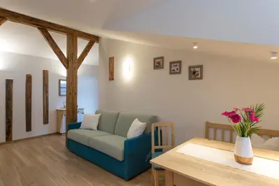 a living room with a couch and a table at Ansitz Mairhof in Parcines