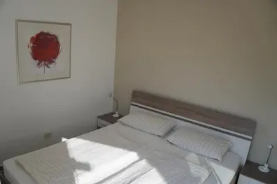 a white bed with two pillows in a bedroom at Apartment Roma in Merano