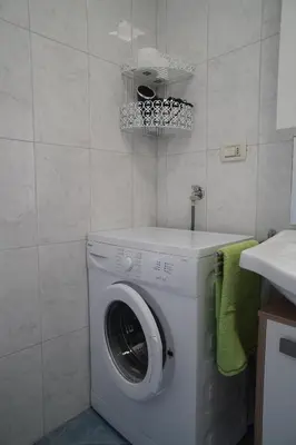 a washing machine in a bathroom with a sink at Apartment Roma in Merano