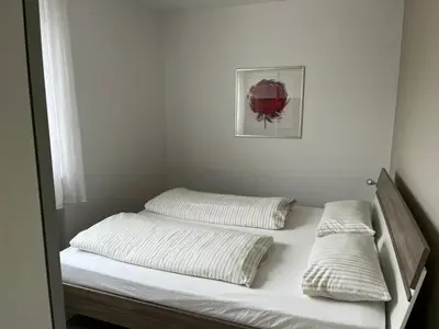 a bed with two pillows on it in a room at Apartment Roma in Merano