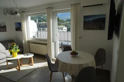 a living room with a table and a couch at Apartment Roma in Merano