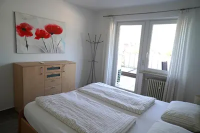 a bedroom with two beds and a dresser and a window at Apartment Roma in Merano