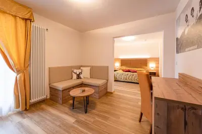 a living room with a couch and a bed at Hotel Torretta in Bellamonte