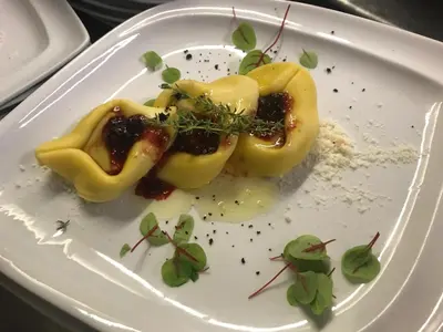 a white plate with some food on it at Hotel Olaga in Valdaora