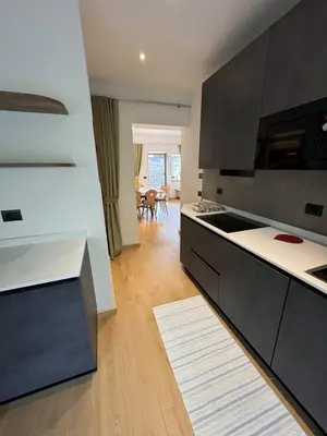 a kitchen with black cabinets and a white counter top at Appartamento Continental - 8 posti letto in San Vito di Cadore
