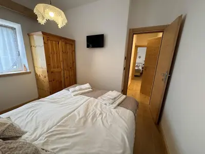 a bedroom with a large bed in a room at Appartamento Continental - 8 posti letto in San Vito di Cadore