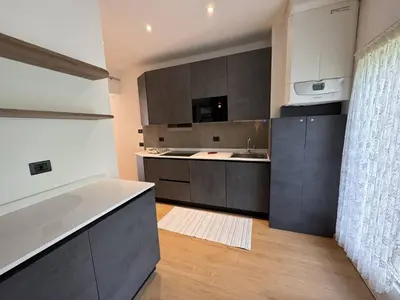 a kitchen with gray cabinets and a counter top at Appartamento Continental - 8 posti letto in San Vito di Cadore