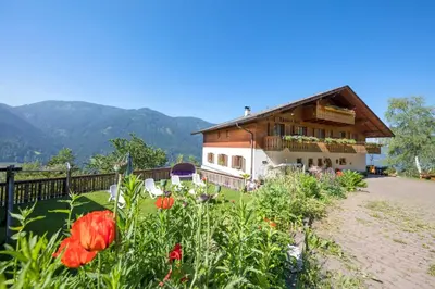 a house with a garden with flowers in front of it at Thalerhof Tiers in Tires
