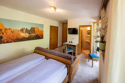 a bedroom with a bed and a desk at Thalerhof Tiers in Tires