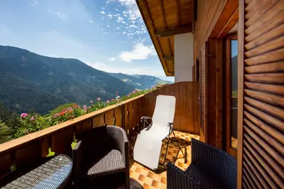a balcony with chairs and a view of a mountain at Thalerhof Tiers in Tires