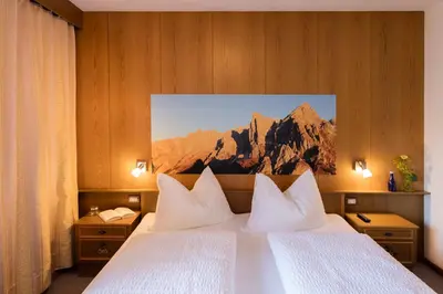 a hotel room with a bed with two white pillows at Thalerhof Tiers in Tires