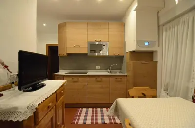 a kitchen with a desk with a tv on it at Continental 101- 4 beds in San Vito di Cadore