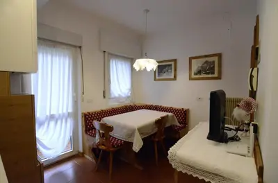 a dining room with a table and a television at Continental 101- 4 beds in San Vito di Cadore