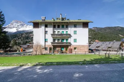 a large building in front of a mountain at Continental 101- 4 beds in San Vito di Cadore