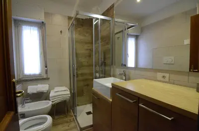 a bathroom with a shower and a sink and a toilet at Continental 101- 4 beds in San Vito di Cadore