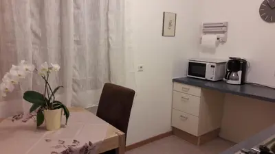 a kitchen with a table and a microwave on a counter at 