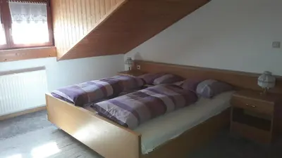 a bed in a bedroom with two pillows on it at 