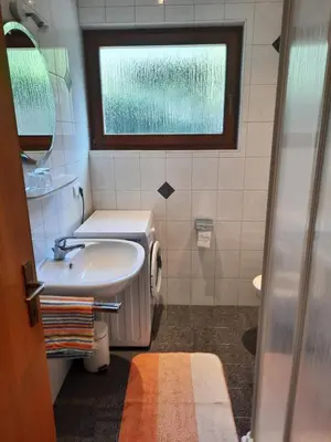 a small bathroom with a sink and a window at 