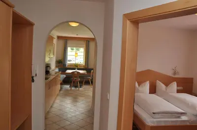 a hotel room with a bed and a dining room at Apartment Residence Volgger in Brunico