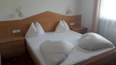 a bed with two white pillows on top of it at Apartment Residence Volgger in Brunico