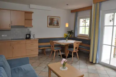 a kitchen and living room with a table and chairs at Apartment Residence Volgger in Brunico