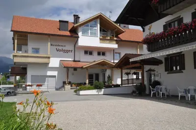 a large white building with a balcony at Apartment Residence Volgger in Brunico