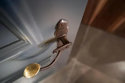 a bronze door handle on a bathroom door at Messnerhaus Suite in Siusi