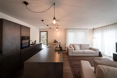 a living room with a couch and a table at Messnerhaus Suite in Siusi
