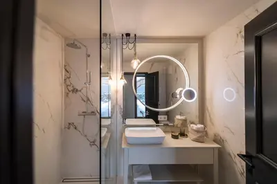 a bathroom with a sink and a mirror at Messnerhaus Suite in Siusi