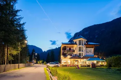 a large house on the side of a road at Chalet Pineta relax location in Canazei