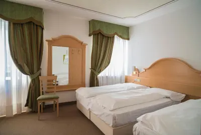 a toy train sitting on top of a bed at Hotel Monzoni - San Pellegrino in Passo San Pellegrino