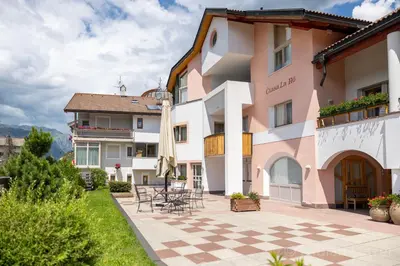 a view of a building with a patio at Ciasa La Rô in San Cassiano
