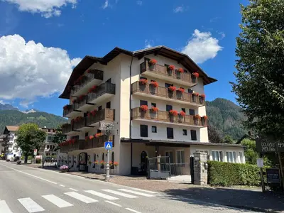 a building with balconies on the side of a street at Albergo Dolomiti in Fiera di Primiero