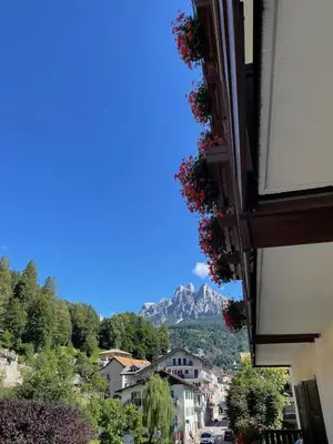 a view of a city with a mountain in the background at Albergo Dolomiti in Fiera di Primiero