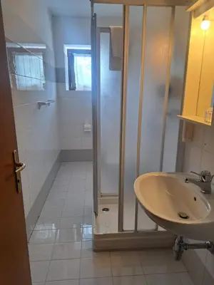 a bathroom with a shower and a sink at Albergo Dolomiti in Fiera di Primiero