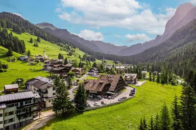 a village in a valley in the mountains at Aparthotel Princess in Canazei